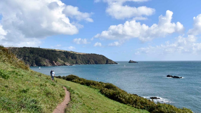 Walkers on the coastal path at Little Dartmouth, Devon